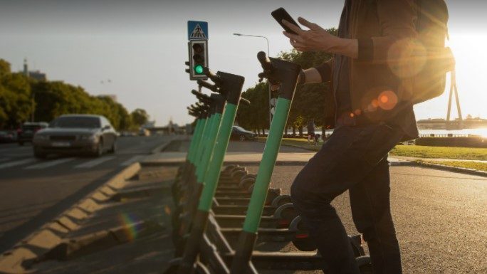 Person standing near electric scooters