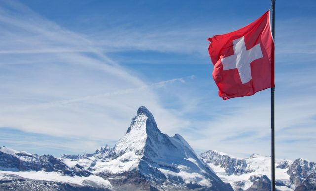 Swiss flag over the mountains