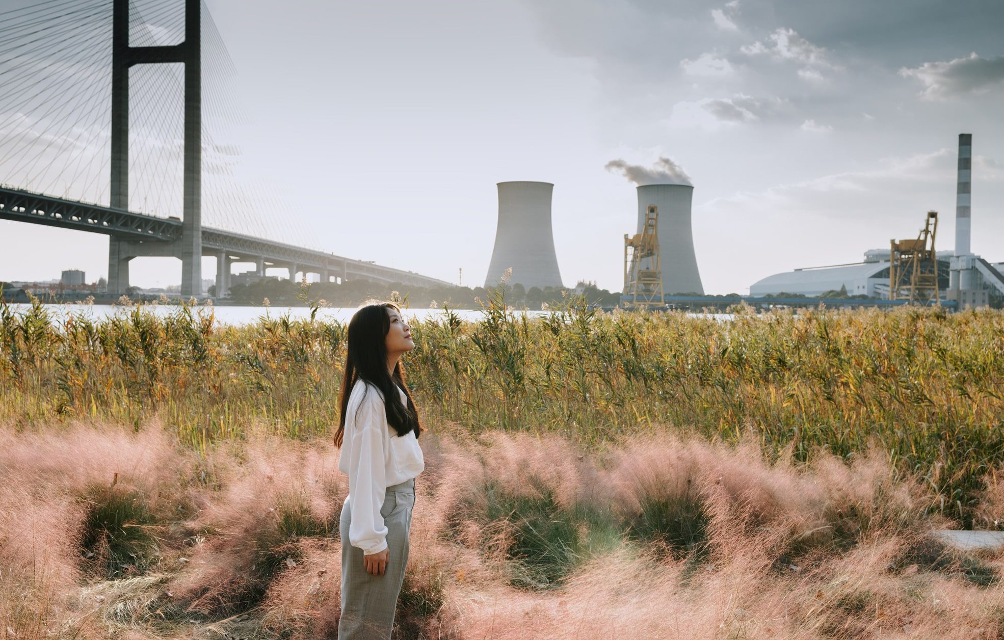 Asian woman standing near cooling tower