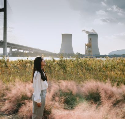 Asian woman standing near cooling tower