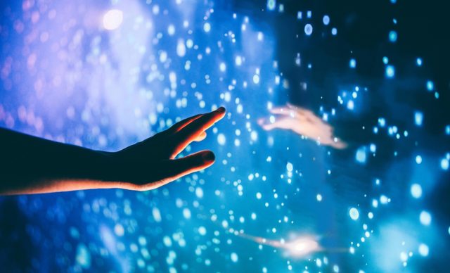 A human hand reaching out to the dark unknown