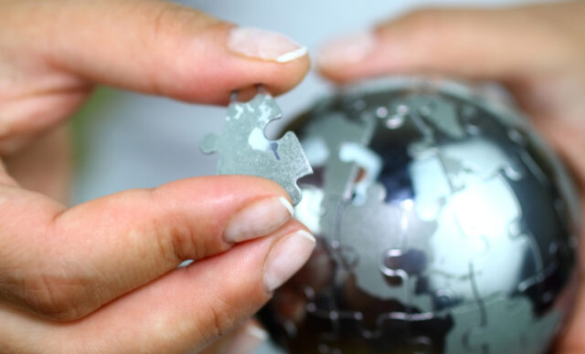 Woman holding globe puzzle