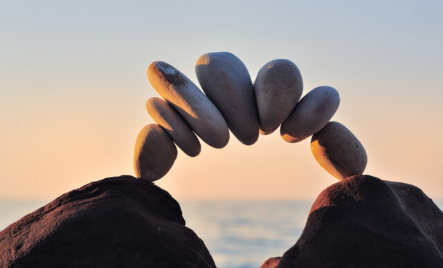 Arc of pebbles between of the stones on the coast